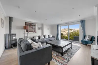 a living room with a couch and a coffee table at Ligger View in Perranporth
