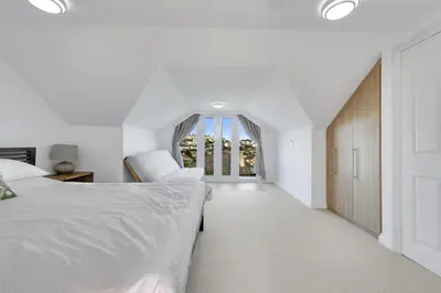 a bedroom with two beds and a window at Ligger View in Perranporth