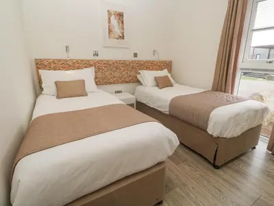 a bedroom with two beds and a window at Hepworth in Redruth