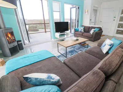 a living room with a couch and a fireplace at Hepworth in Redruth