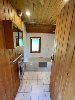 a bathroom with a tub and a sink and a washing machine at 3 Bedroom Lodge Lanteglos 21 in Lanteglos
