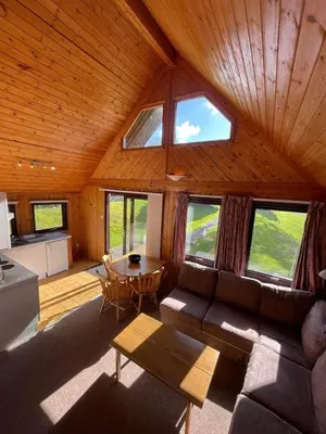 a living room with a couch and a table at 3 Bedroom Lodge Lanteglos 21 in Lanteglos