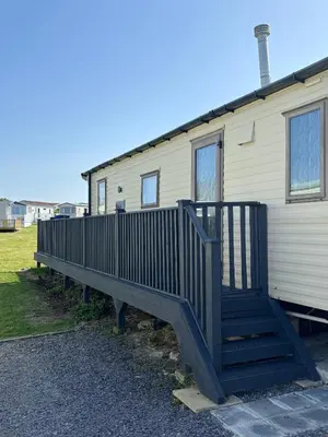 a stairway leading up to a mobile home at Padstow Holiday Base Bright Two Bedroom Lodge at Seven Bays in St Merryn