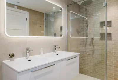 a bathroom with a white sink and a shower at Heron House in Newquay