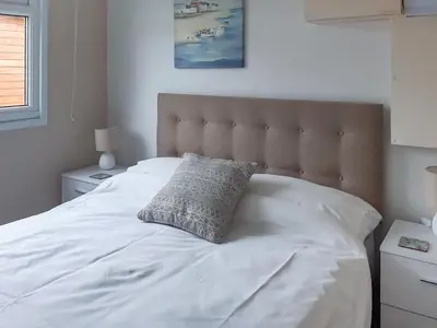 a white bed with a pillow on top of it at Atlantic Retreat in Padstow