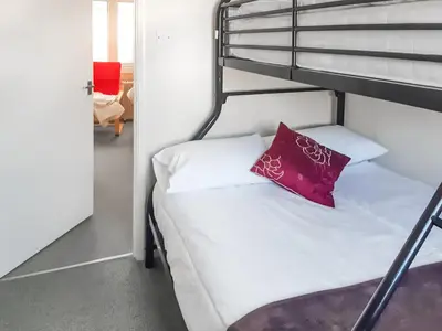 a bedroom with a bunk bed with a red pillow at Atlantic Retreat in Padstow