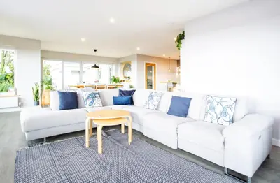 a living room with a white couch and a table at Tregaron in Penryn