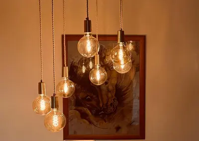 a group of lights hanging from a wall with a picture at Tregaron in Penryn