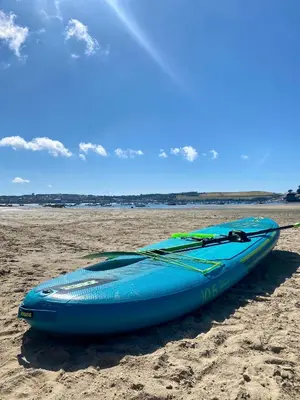 a blue kayak sitting on a sandy beach at Riverside farm cottage on private wildlife estate 3-bedrooms in Washaway