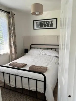 a bedroom with a bed with two towels on it at 85 Strawberry Hill Hayle in Hayle