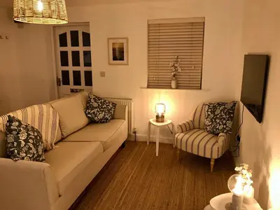 a living room with a couch and a chair at Little Peterville in St. Agnes