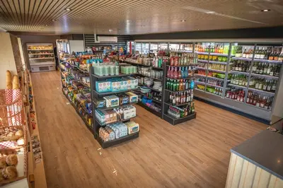 a store aisle of a grocery store with many products at Meadow & Tide in St Merryn