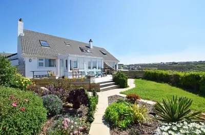 a house with a garden with flowers and plants at One bed spectacular ocean views, walk to the beach in Truro