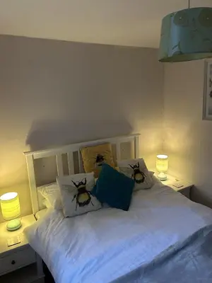 a bedroom with a bed with two bees on the pillows at The New Inn in Veryan