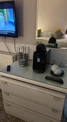 a desk with a computer and a tv on top at The New Inn in Veryan