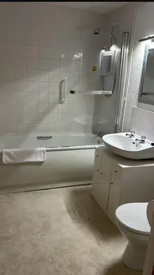a bathroom with a sink and a tub and a toilet at The New Inn in Veryan