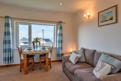 a living room with a couch and a table at Finest Retreats - Chy Merthen East in Marazion