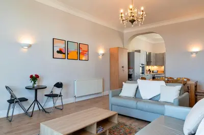 a living room with a couch and a table at Finest Retreats - Tidal Shores in Newquay