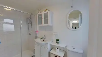 a white bathroom with a sink and a shower at B12 Branksome, Riviere Towans in Hayle