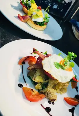 two plates of food sitting on a table at The Ship Inn Fowey in Fowey