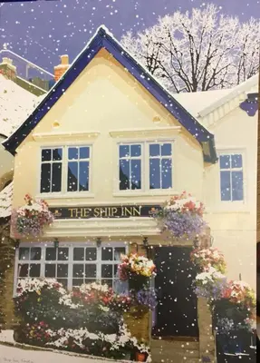 a building with a sign that reads the stick inn at The Ship Inn Fowey in Fowey