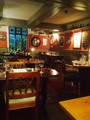a restaurant with tables and chairs in a room at The Ship Inn Fowey in Fowey