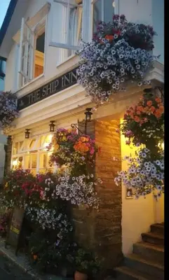 a building with flowers on the side of it at The Ship Inn Fowey in Fowey