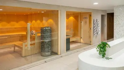 a room with glass walls and a room with at St Moritz Hotel Apartments in Polzeath