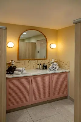 a bathroom with a sink and a mirror at St Moritz Hotel Apartments in Polzeath