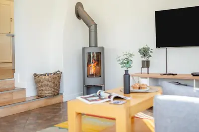 a living room with a wood stove in a living room at 5 Bed in Trevone oc-s30762 in Padstow