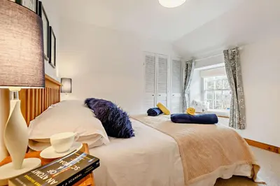 a bedroom with two beds and a window at 2 Bed in St. Minver oc-p27580 in Saint Minver