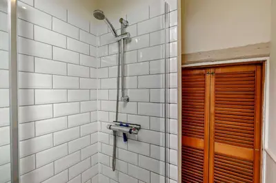 a shower in a bathroom with white tiles at 2 Bed in St. Minver oc-p27580 in Saint Minver
