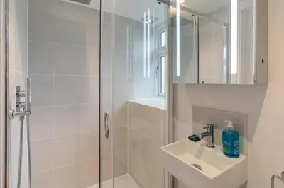 a white bathroom with a shower and a sink at 2 Bed in St. Ives oc-k30934 in Carbis Bay