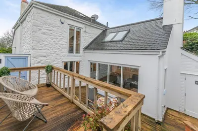 a house with a wooden deck with a chair at 2 Bed in St. Ives oc-k30934 in Carbis Bay