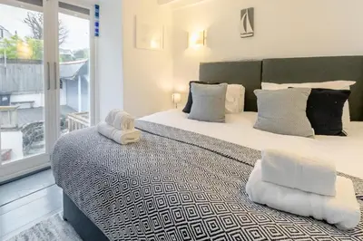 a bedroom with two beds and a balcony at 2 Bed in St. Ives oc-k30934 in Carbis Bay