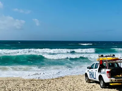 a police truck parked on a beach with the ocean at Ideally located cottage in Downalong St Ives in St Ives