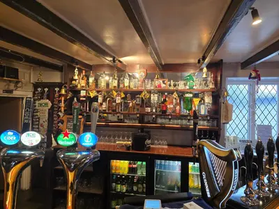 a bar with a lot of bottles of alcohol at Ring O Bells in St. Issey