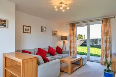 a living room with a couch with red pillows at Finest Retreats - Chy Merthen House in Marazion