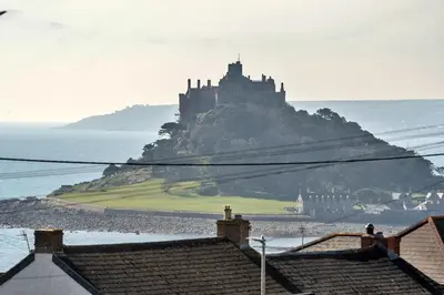 a castle sitting on top of an island in the water at Finest Retreats - Chy Merthen House in Marazion