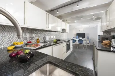a kitchen with a counter with fruits and vegetables on it at Salubrious Cottage, St Ives in St Ives