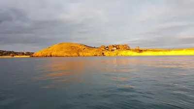 an island in the middle of a body of water at Cornwall Luxury Hot Tub Huts in Camelford