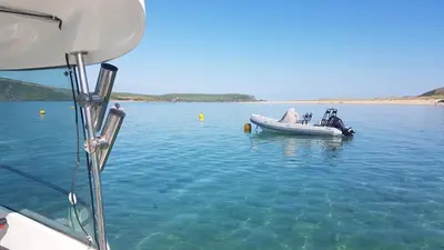 a small boat floating in the water at Cornwall Luxury Hot Tub Huts in Camelford