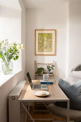 a table with a laptop on it in a room at 1 Rock Cottages in Treknow