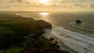 an aerial view of the ocean and a rocky shoreline at 1 Rock Cottages in Treknow