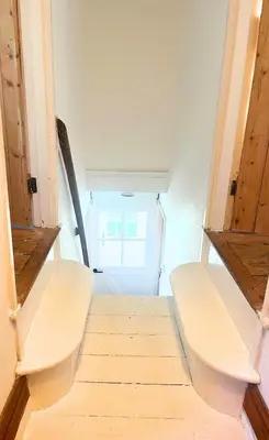 a hallway with two benches in a room at 1 Rock Cottages in Treknow