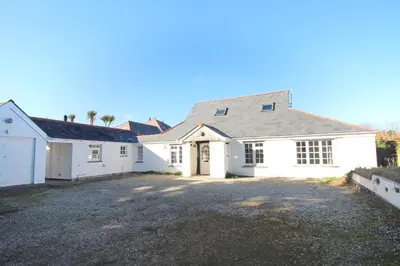 a large white house with a driveway at ON THE BEACH holiday home in St Merryn
