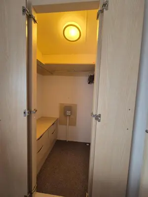 a room with a closet with a light on the ceiling at Cosy Perranporth caravan, Cornwall in Perranzabuloe