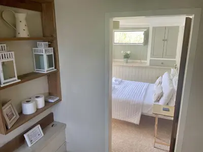 a small bedroom with a bed and a window at The Cow Shed in Wadebridge