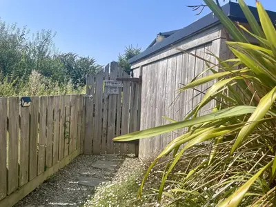 a wooden fence next to a wooden building at The Cow Shed in Wadebridge