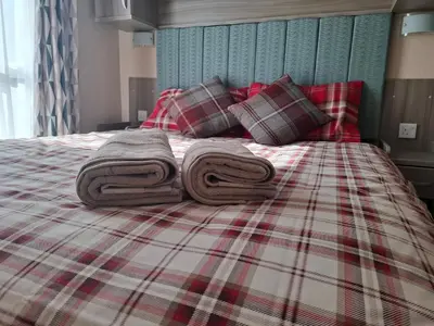 a bed with towels on top of it at St Merryn in St Merryn